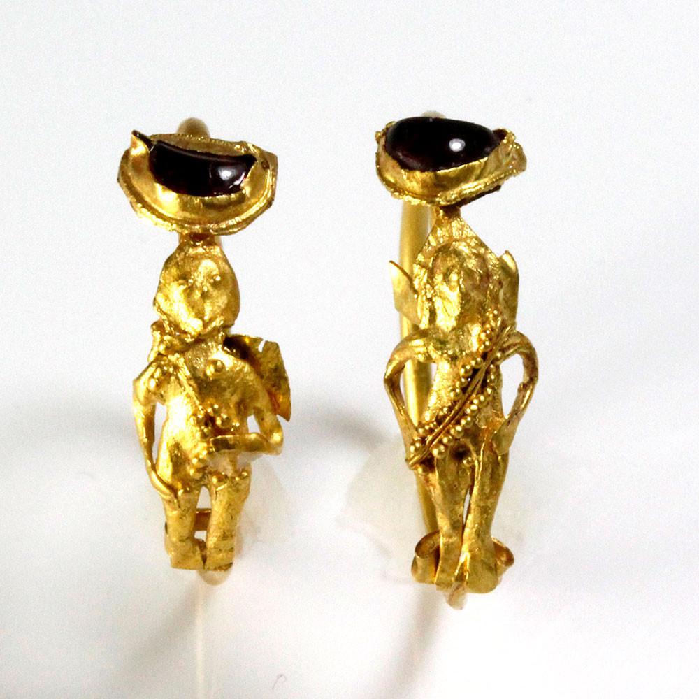 A Pair of Gold & Garnet Earrings of Eros, Hellenistic Period, ca. 2nd - 1st century BCE