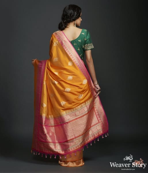 Mango yellow dual tone kadhiyal border saree with a kadhwa booti and pink selvedge