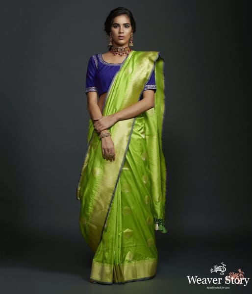 Neon Green kadhwa booti saree with zari border and a blue selvedge