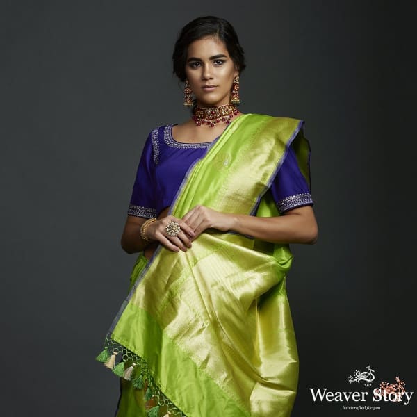 Neon Green kadhwa booti saree with zari border and a blue selvedge