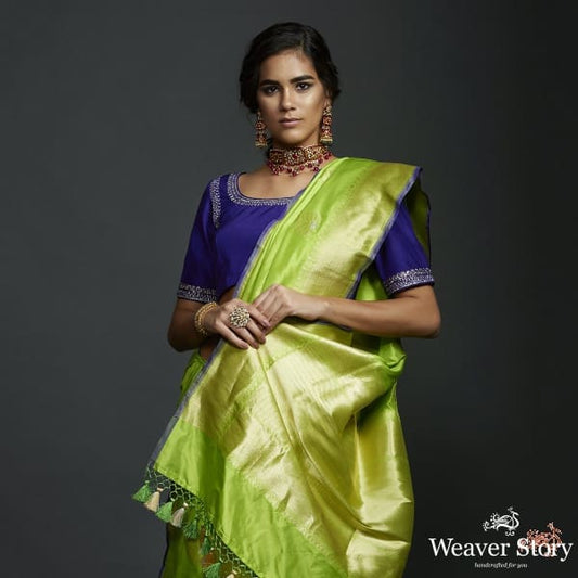 Neon Green kadhwa booti saree with zari border and a blue selvedge