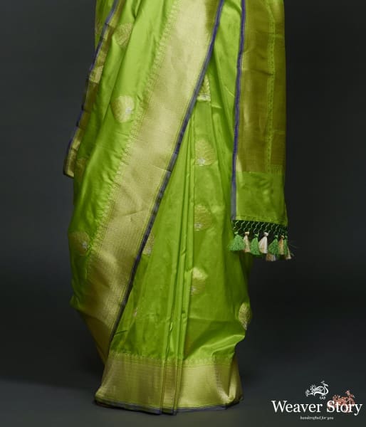 Neon Green kadhwa booti saree with zari border and a blue selvedge