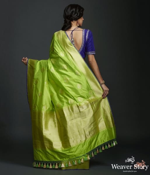 Neon Green kadhwa booti saree with zari border and a blue selvedge