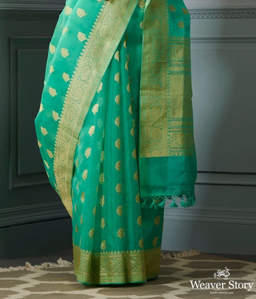 Green banarasi kora saree with beldar border and kairi boota