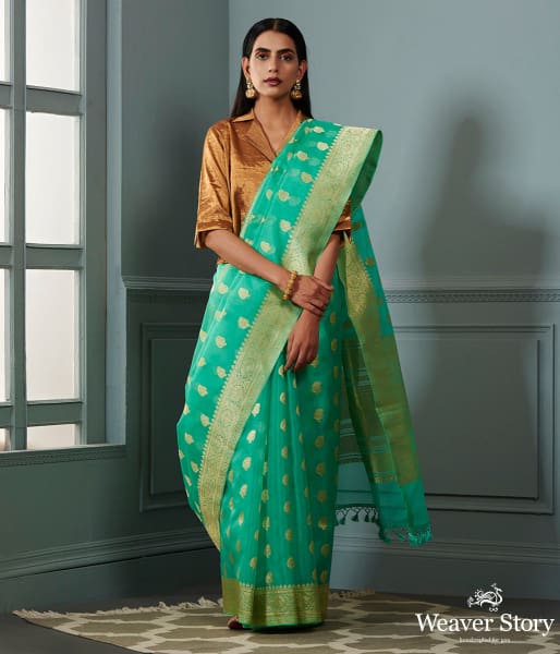Green banarasi kora saree with beldar border and kairi boota