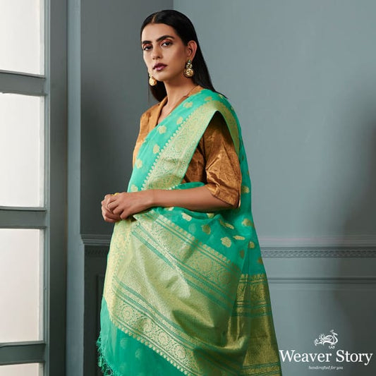 Green banarasi kora saree with beldar border and kairi boota