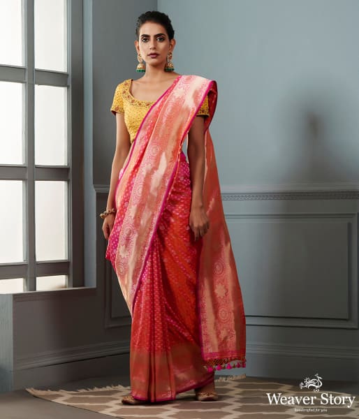 Handwoven Banarasi saree in Pink and peach dual tone with broad floral border