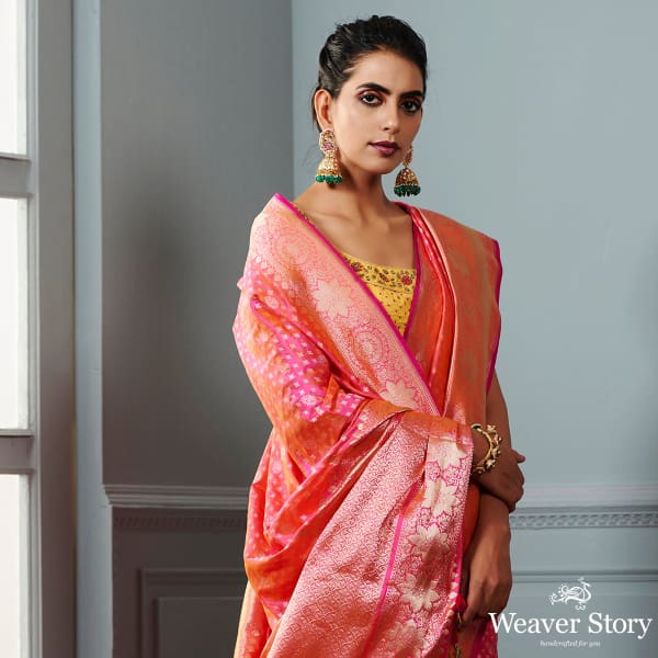 Handwoven Banarasi saree in Pink and peach dual tone with broad floral border
