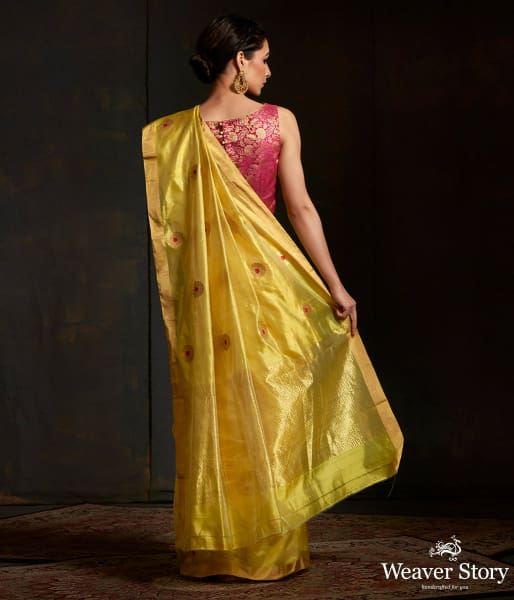 Lime green chanderi silk saree with floral bootis in gold zari with meenakari.
