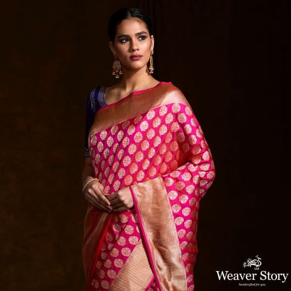 Handwoven pink katan silk saree with floral motifs and zari border