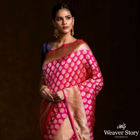 Handwoven pink katan silk saree with floral motifs and zari border