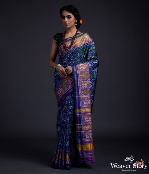 Blue dual tone single ikat patola saree with a purple and gold tissue border