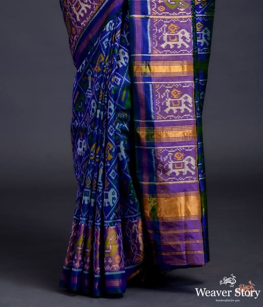 Blue dual tone single ikat patola saree with a purple and gold tissue border