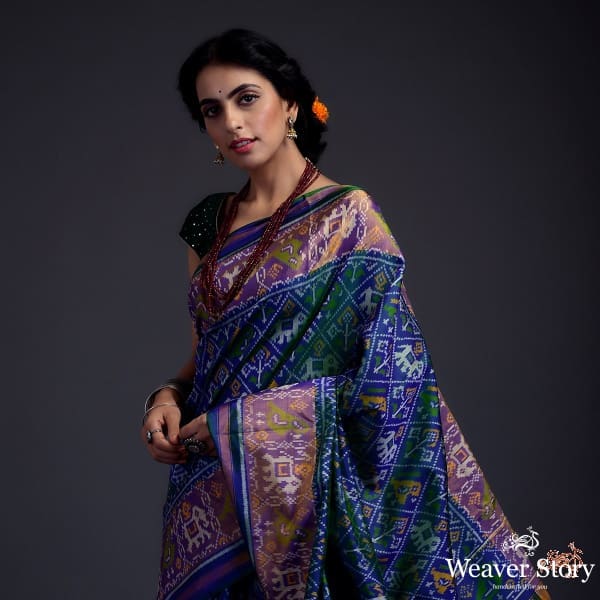 Blue dual tone single ikat patola saree with a purple and gold tissue border