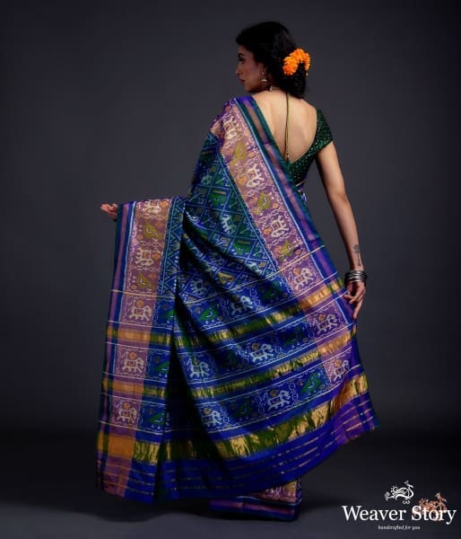 Blue dual tone single ikat patola saree with a purple and gold tissue border