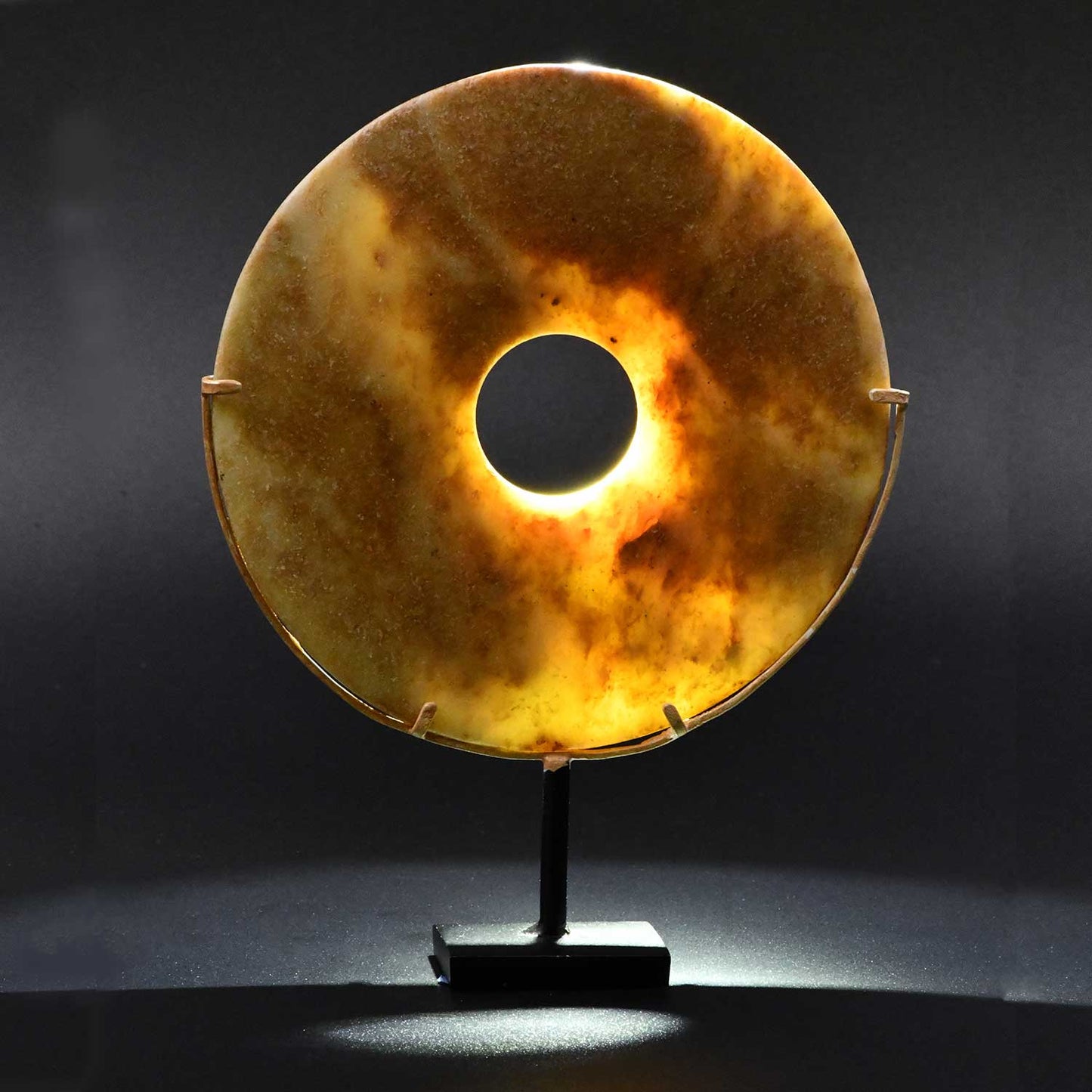 A Chinese Mottled Nephrite Jade Bi Disc, Late Neolithic Period, ca. 3000 - 2000 BCE