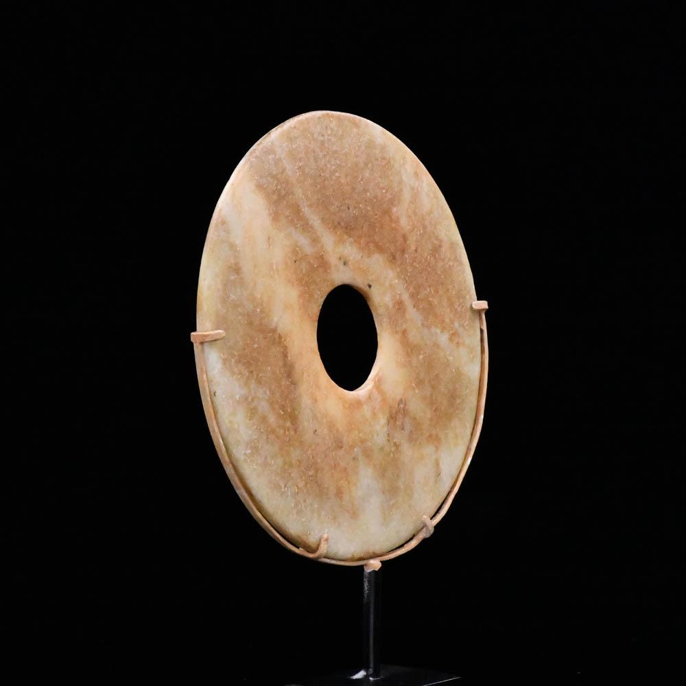 A Chinese Mottled Nephrite Jade Bi Disc, Late Neolithic Period, ca. 3000 - 2000 BCE