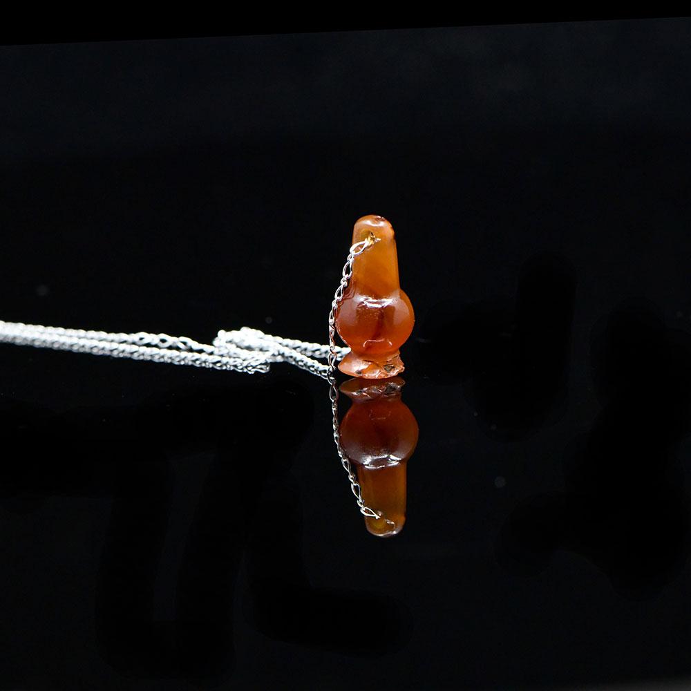 An Egyptian Carnelian Poppy Bead Pendant, New Kingdom, 18th - 19th Dynasty, ca. 1550 - 1295 BCE