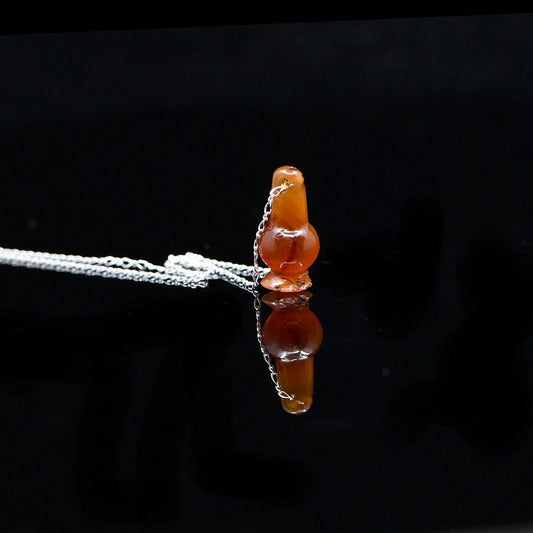 An Egyptian Carnelian Poppy Bead Pendant, New Kingdom, 18th - 19th Dynasty, ca. 1550 - 1295 BCE