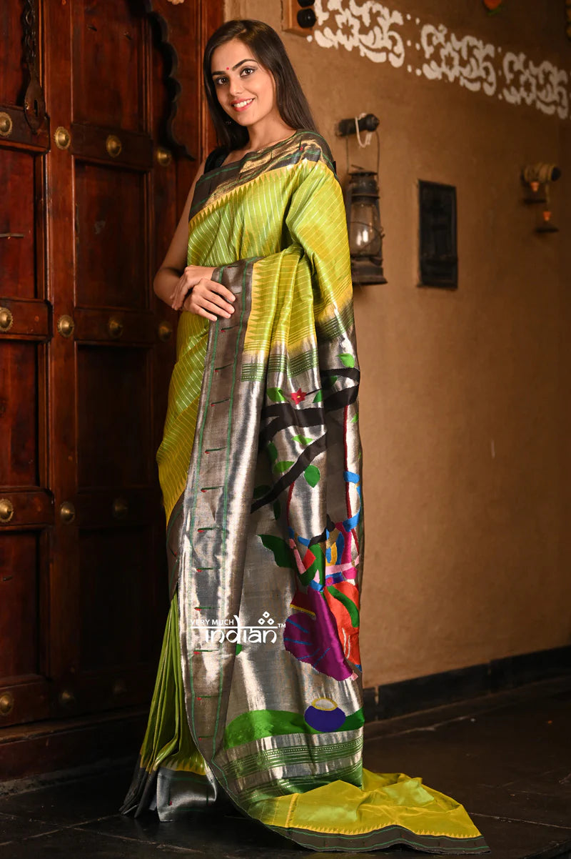 Abhimaan ~ Premium Handloom Pure Silk Muniya Border in unique combination of Light Parrot Green,Silver Zari and Intricate Big Radha Krishna Pallu