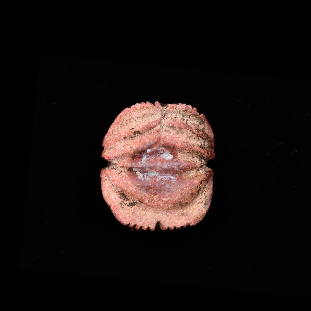 An Egyptian Red Glazed Steatite Scarab, Late Period, ca. 664 - 332 BCE