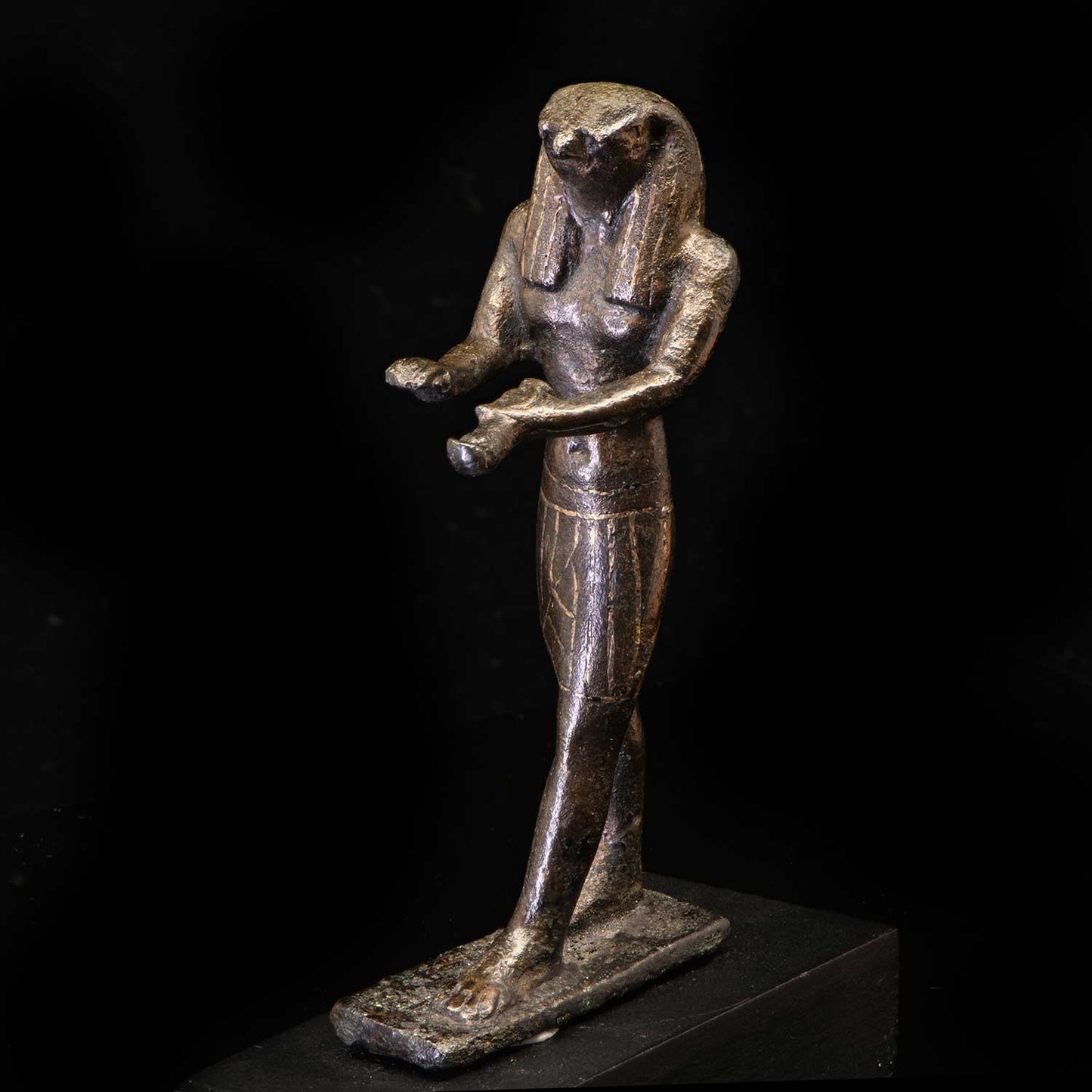 An Egyptian Gold-Inlaid Bronze Falcon, Third Intermediate Period, ca. 900 - 600 BCE