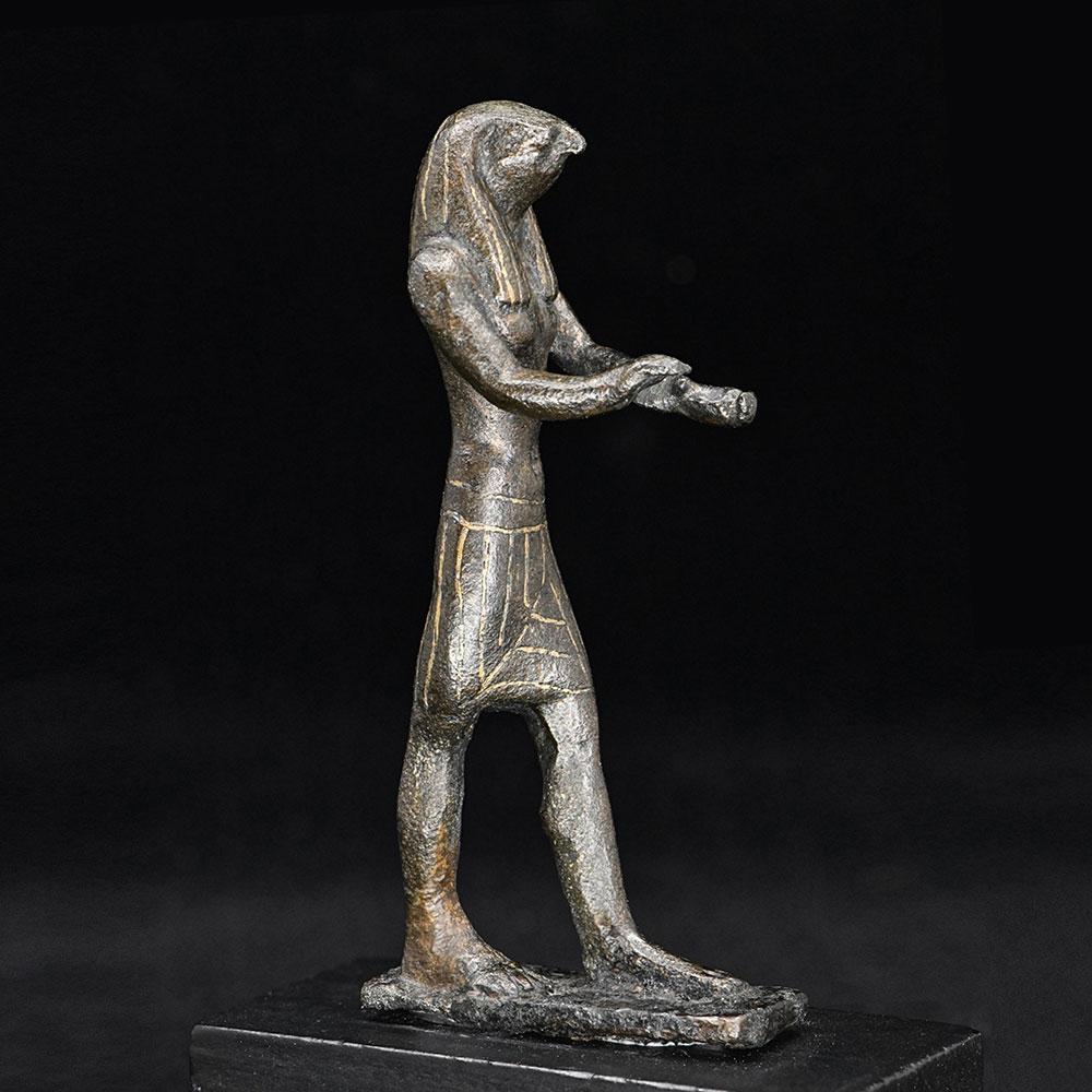 An Egyptian Gold-Inlaid Bronze Falcon, Third Intermediate Period, ca. 900 - 600 BCE