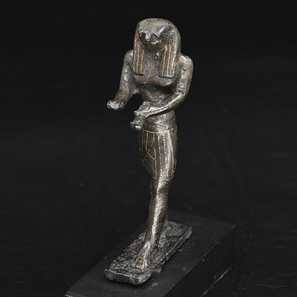 An Egyptian Gold-Inlaid Bronze Falcon, Third Intermediate Period, ca. 900 - 600 BCE
