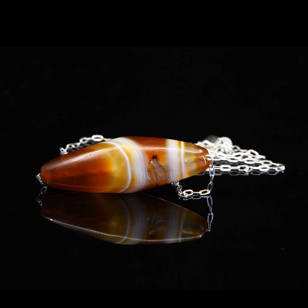 A Western Asiatic Banded Agate Bead Pendant, ca 1st millennium BCE