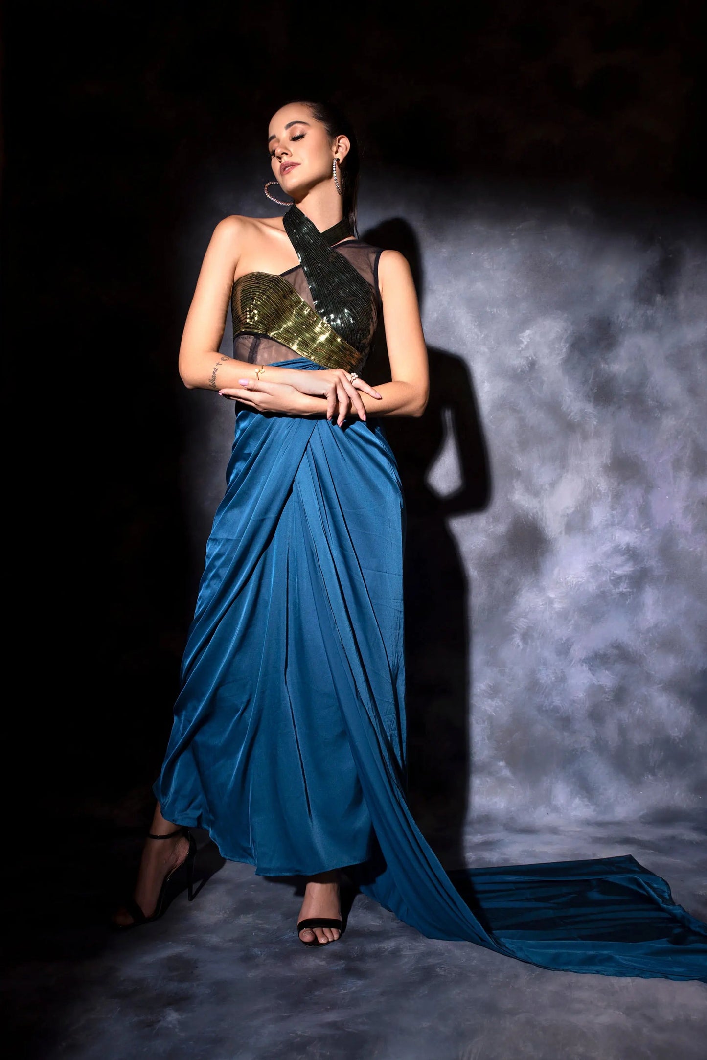 One shoulder drape in teal blue with a metallic molded drape dress