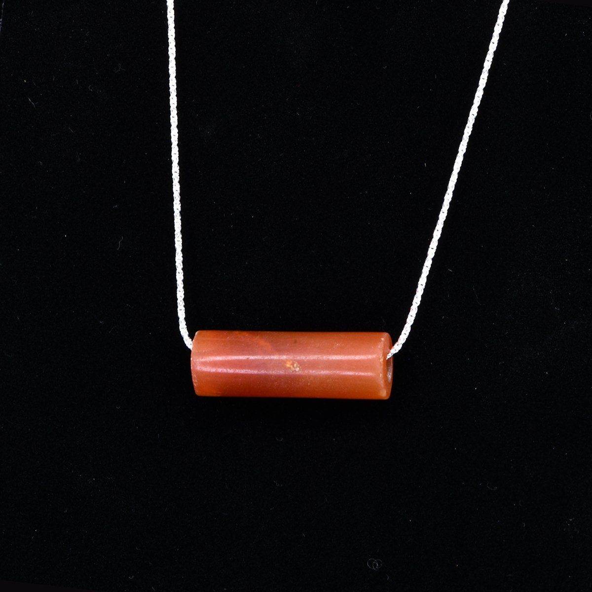 A fine Inca Carnelian Tube Bead, set as a pendant, ca 1400-1560 CE