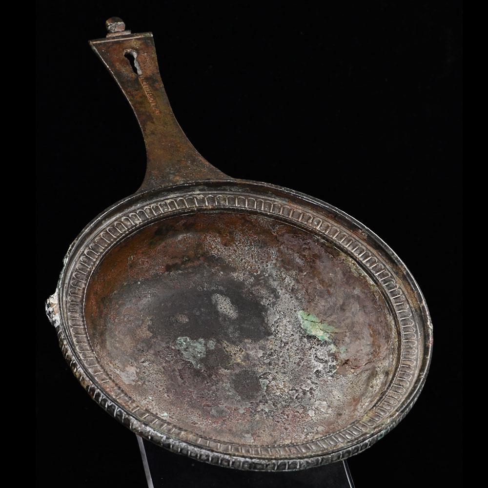 A Roman Military bronze Skillet with maker mark of Publius Cipius Polybius, Flavian Period (65-85 CE)