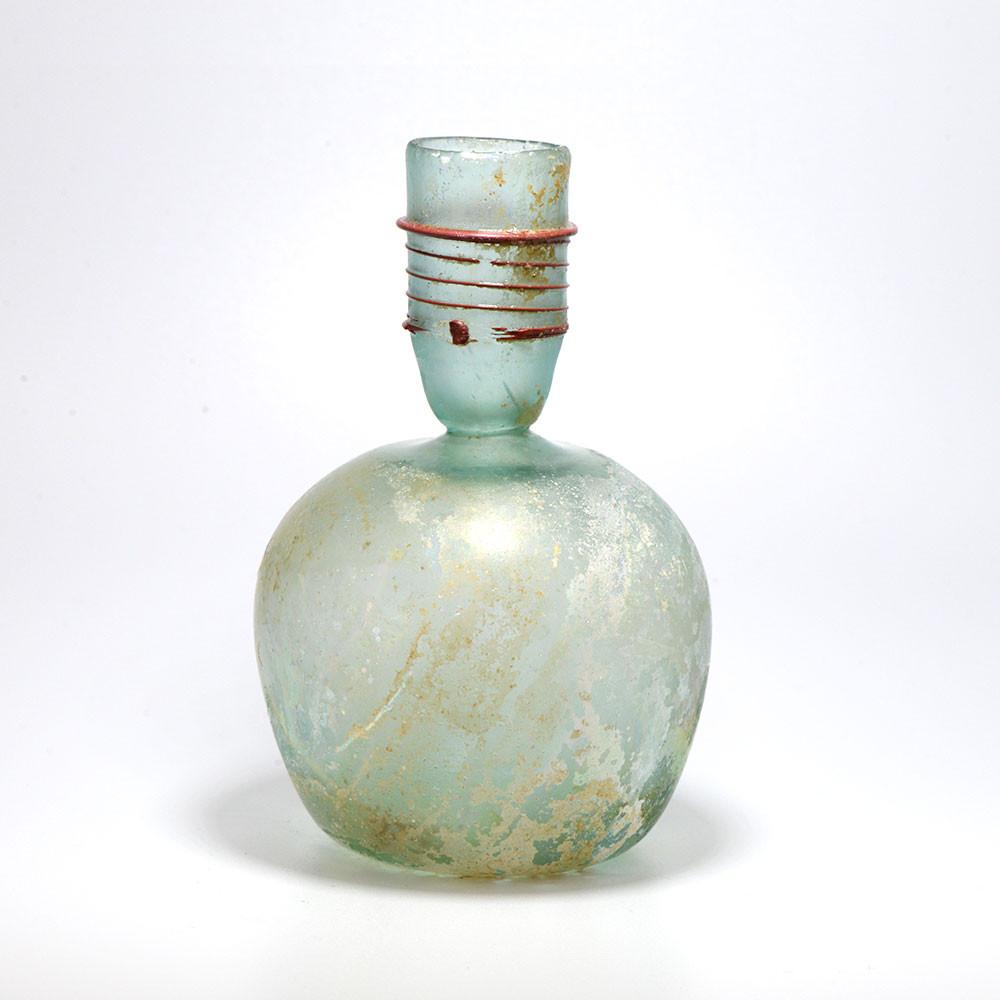 A Roman Green Glass Sprinkler Bottle, 4th Century CE