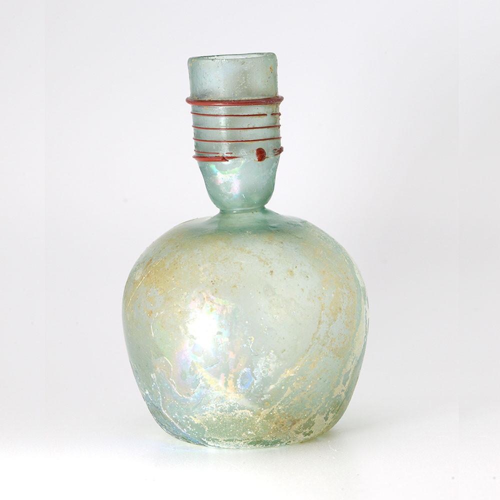 A Roman Green Glass Sprinkler Bottle, 4th Century CE